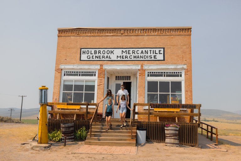 A family steps out of the historic Holbrook Mercantile General Merchandise store.